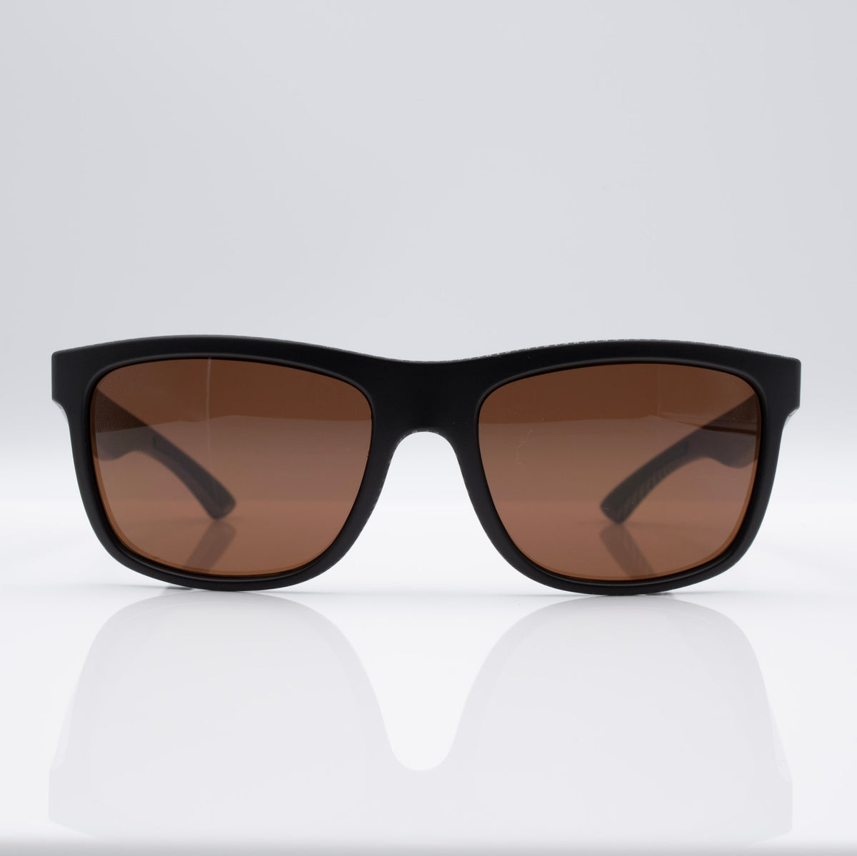 Matte Black Carbon Inverted sunglasses with bronze lenses, angled profile showing carbon-inspired frame detail.