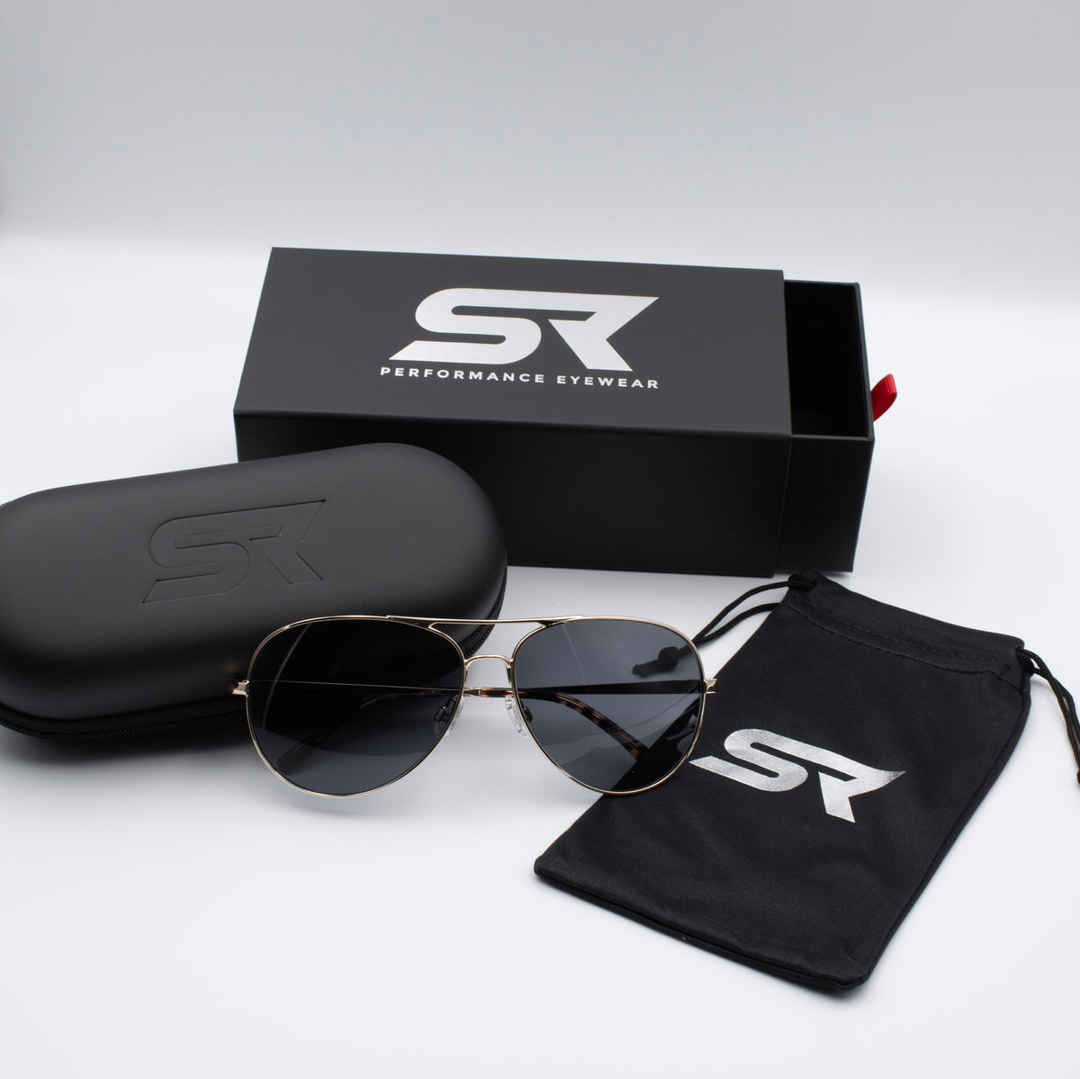 Heritage Gold Blackbird Aviator sunglasses with gray lenses and premium SR Performance Eyewear packaging.