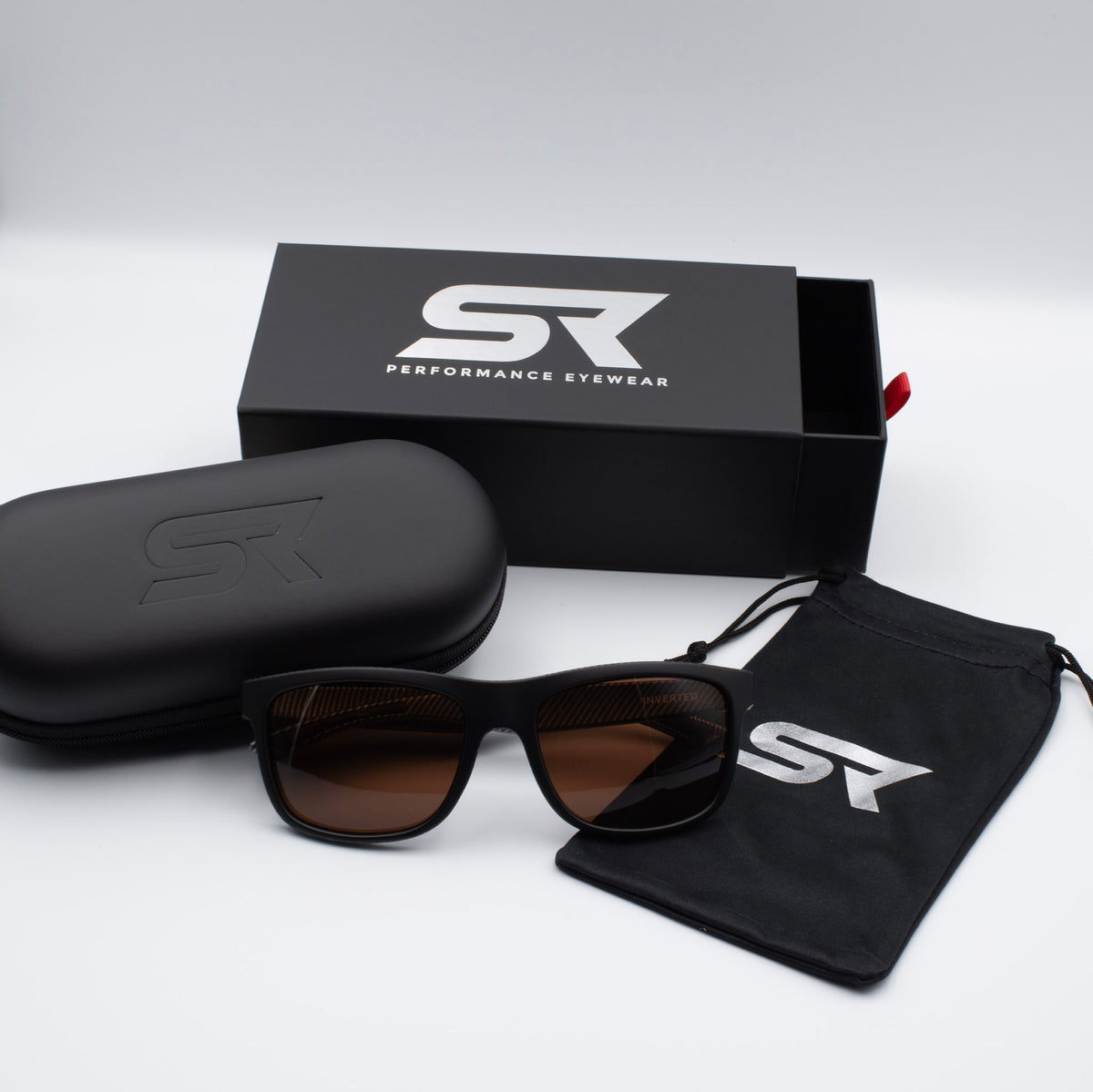 Matte Black Carbon Inverted sunglasses with bronze lenses and premium SR Performance Eyewear packaging.