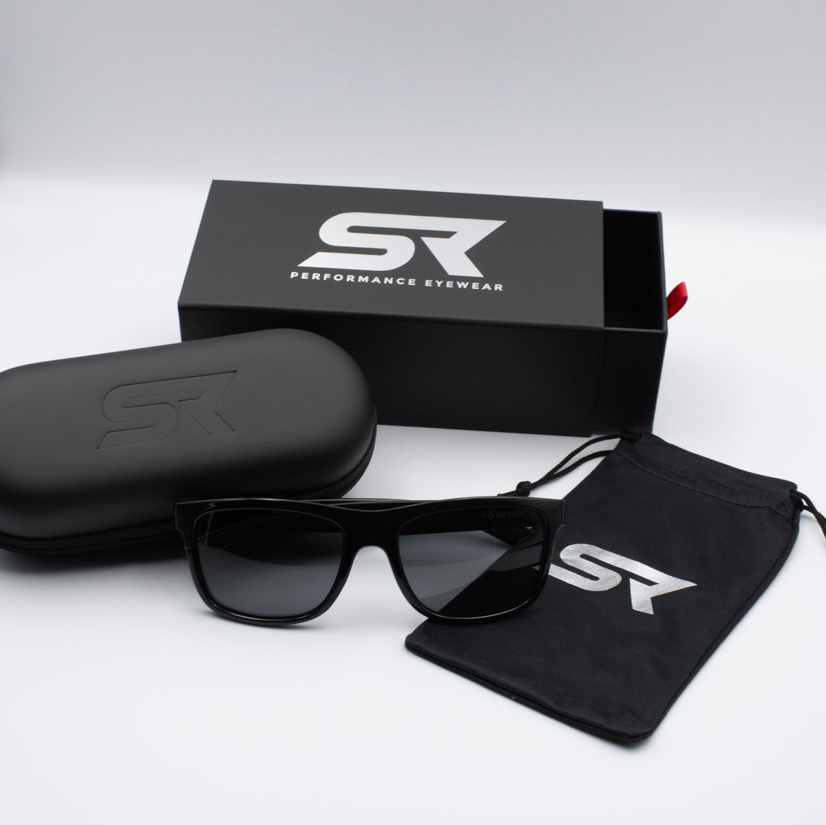 Stealth Gloss Black Inverted sunglasses with gray lenses and premium SR Performance Eyewear packaging.
