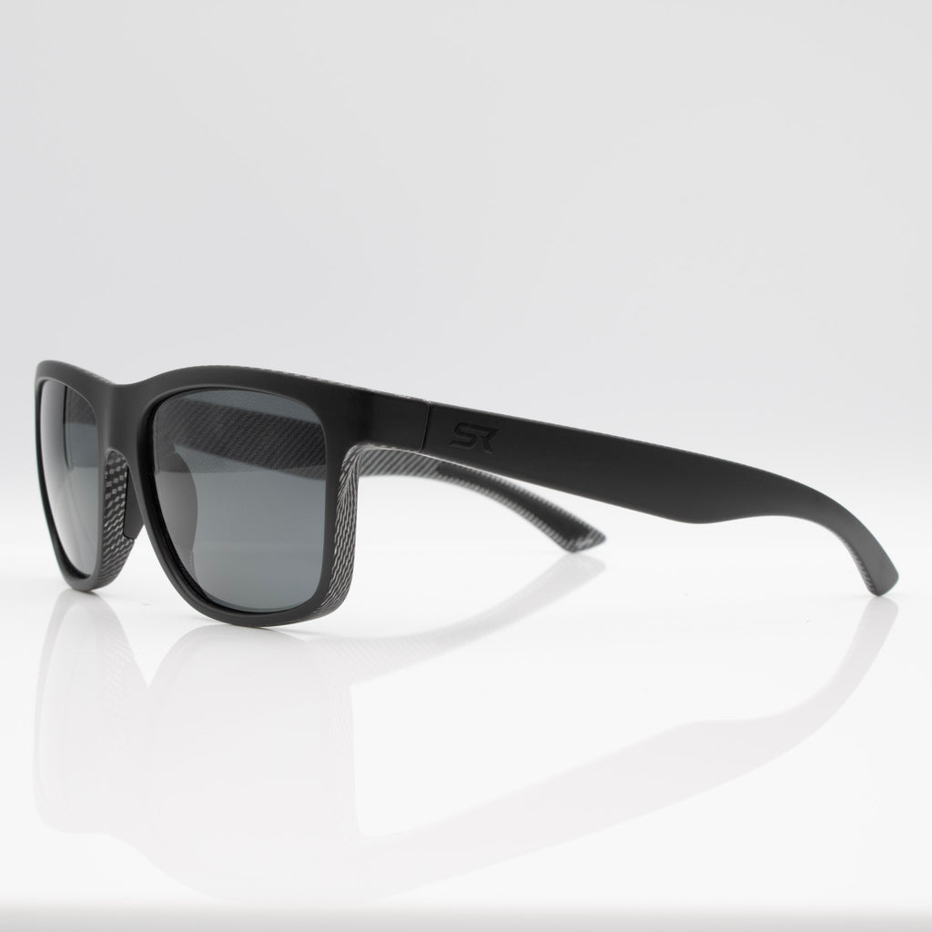 Matte Black Carbon Inverted sunglasses with gray lenses, angled profile showing performance frame shape.