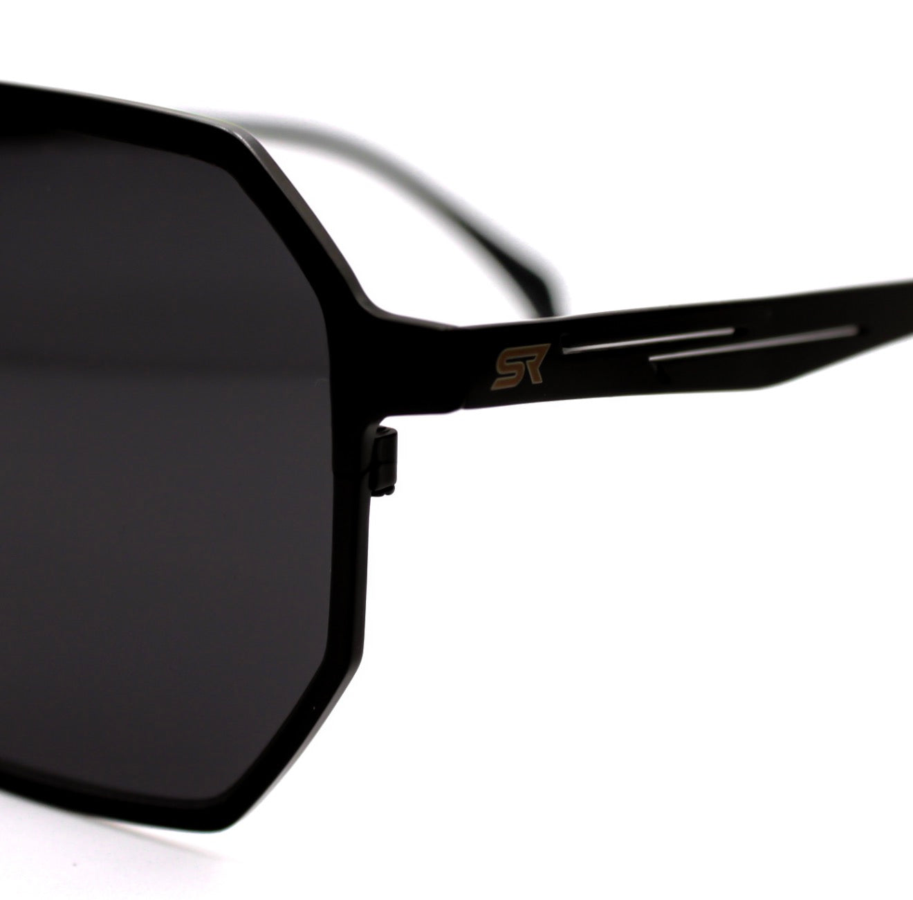 Close-up of SkyRift Vector sunglasses showing pure titanium frame and engraved ST logo