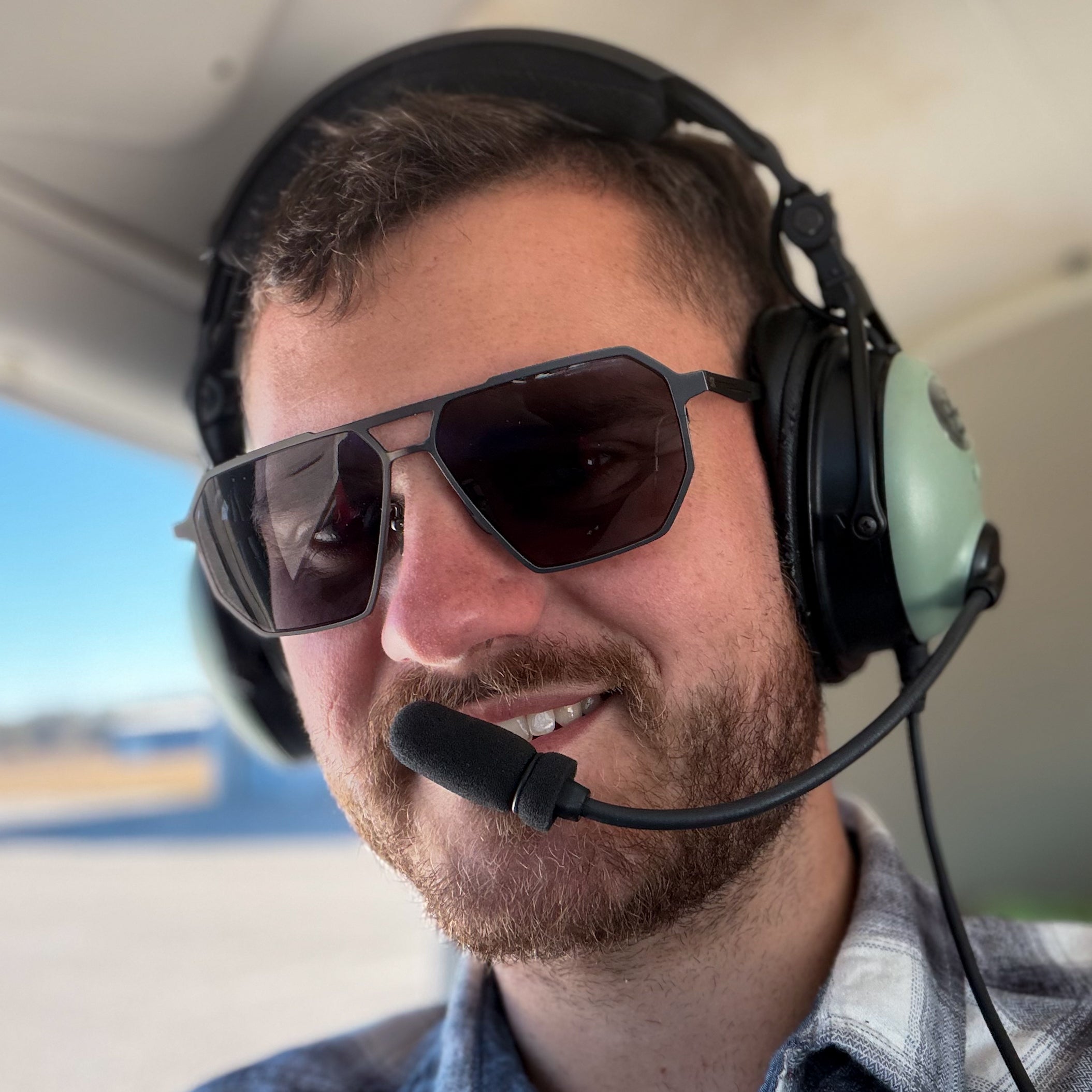 Pilot wearing SkyRift Vector sunglasses inside an aircraft cockpit during real flight conditions