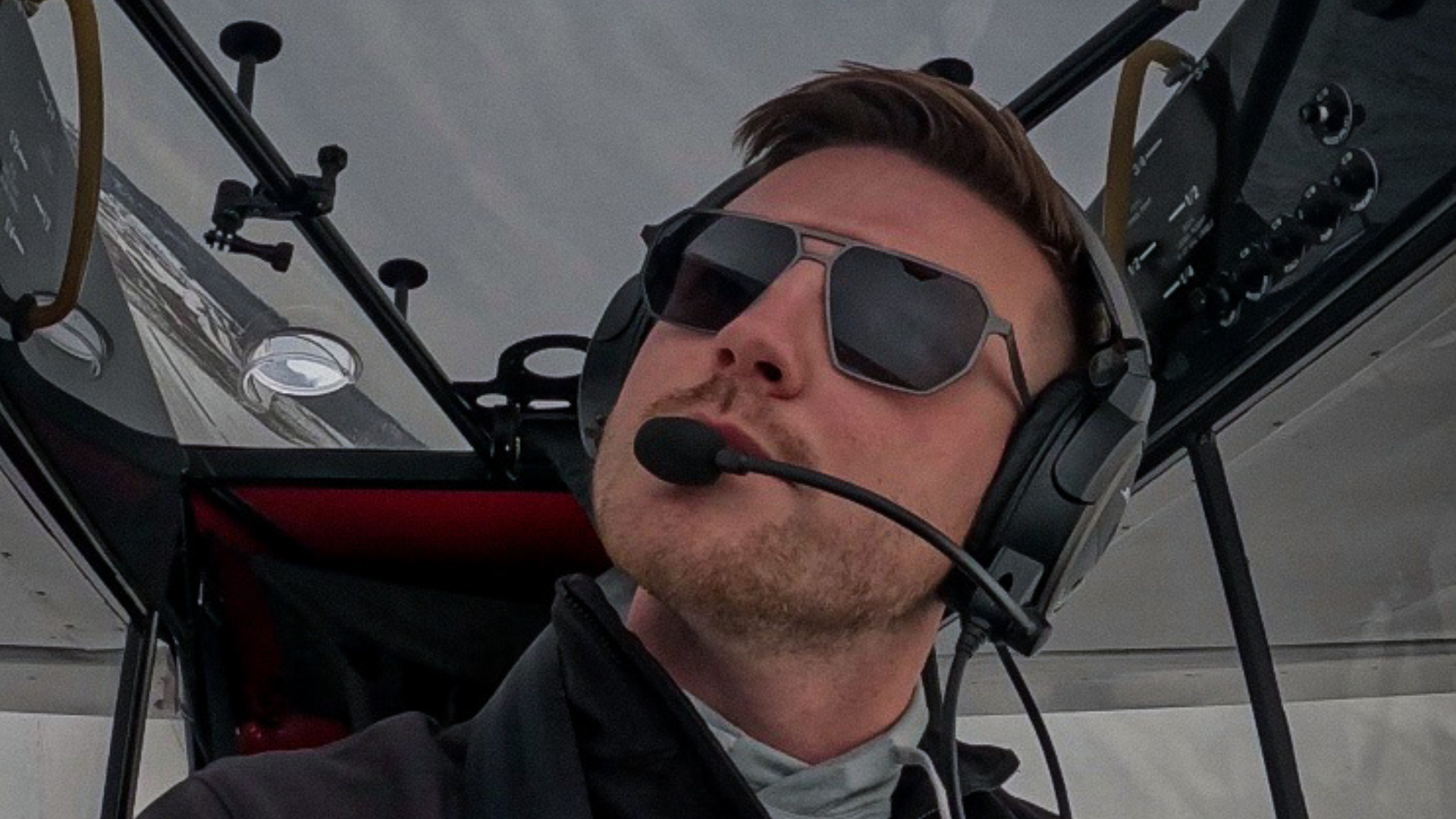 Pilot wearing SkyRift sunglasses in an aircraft cockpit, designed for clarity and performance