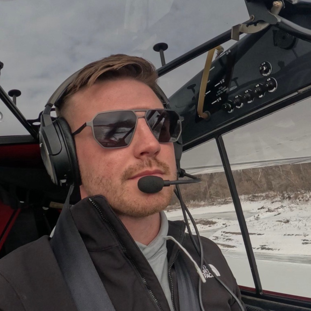 Pilot flying an aircraft while wearing SkyRift Vector sunglasses in the cockpit